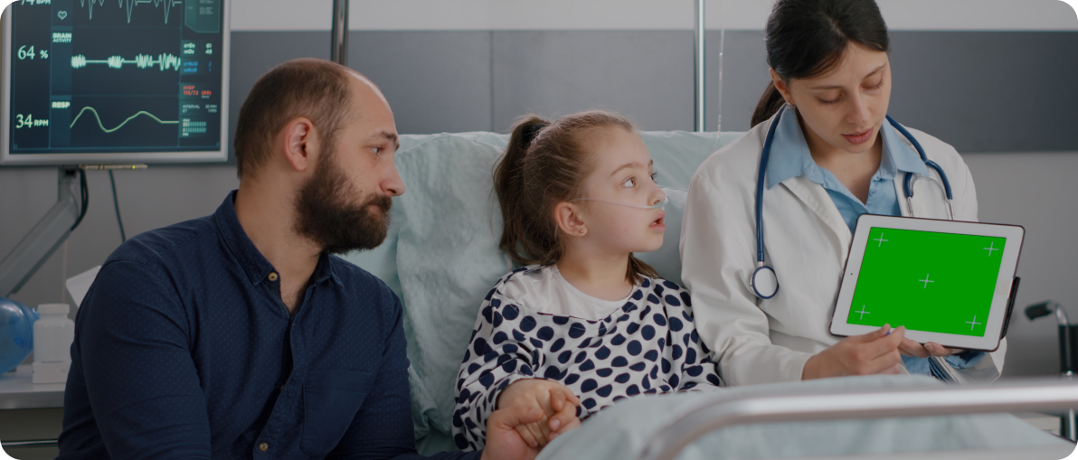 Pediatric doctor explaining symptoms to worried parents with child